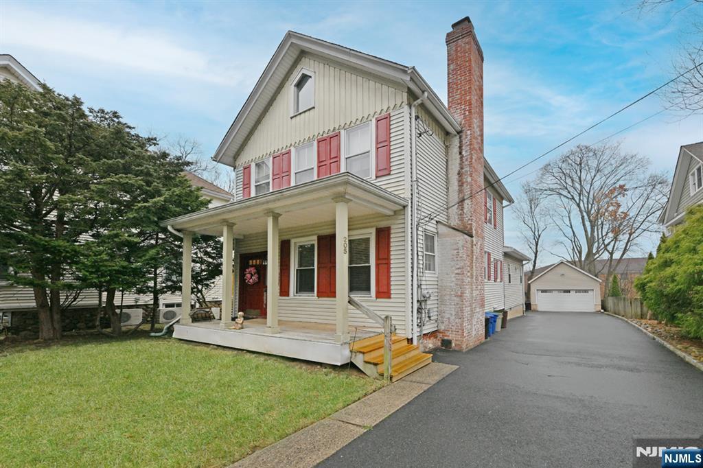 205 Union Street, Unit 2 Ridgewood, NJ 07450 - Photo 3 of 24 a view of a white house with a large windows and a yard