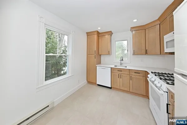 a kitchen with a stove a sink and a window