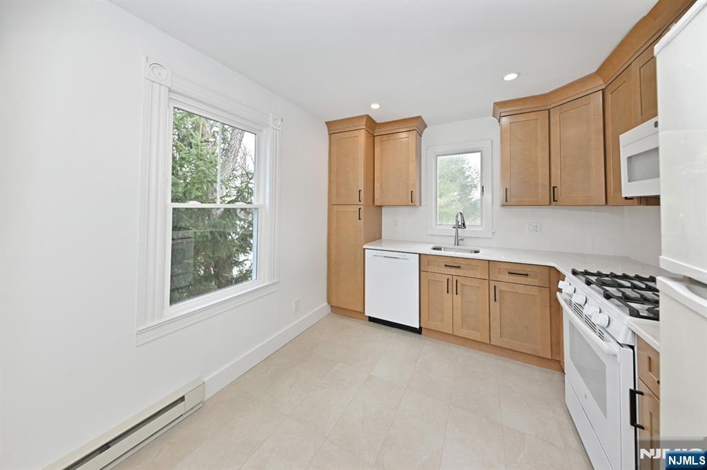 205 Union Street, Unit 2 Ridgewood, NJ 07450 - Photo 9 of 24 a kitchen with a stove a sink and a window