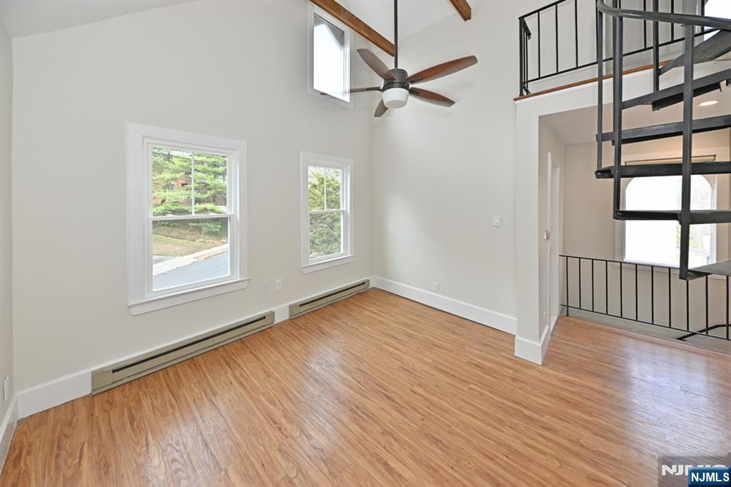 205 Union Street, Unit 2 Ridgewood, NJ 07450 - Photo 10 of 24 a view of an empty room with wooden floor and a window