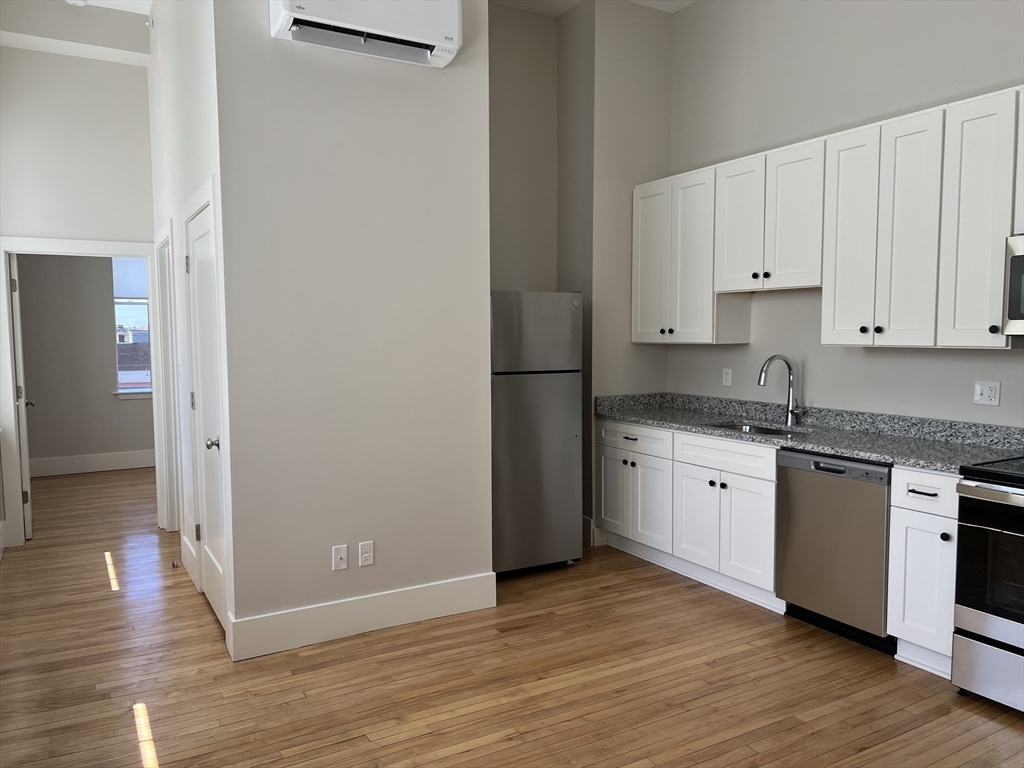 34 St Joseph Street, Unit 21 Fall River, MA 02723 - Photo 1 of 15 a kitchen with granite countertop a refrigerator and a sink