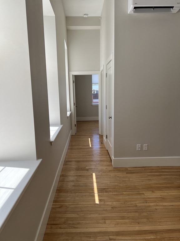 34 St Joseph Street, Unit 21 Fall River, MA 02723 - Photo 3 of 15 a view of a hallway with wooden floor