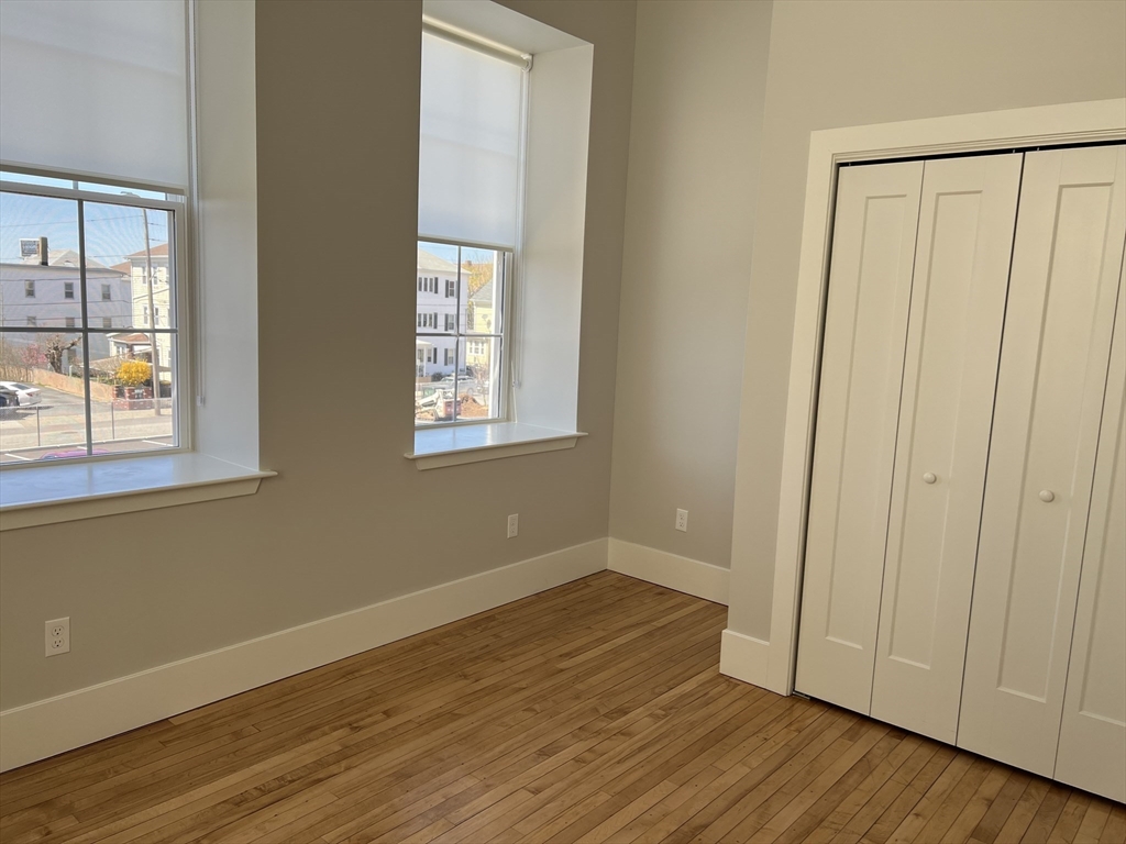 34 St Joseph Street, Unit 21 Fall River, MA 02723 - Photo 5 of 15 a view of an empty room with wooden floor and a window