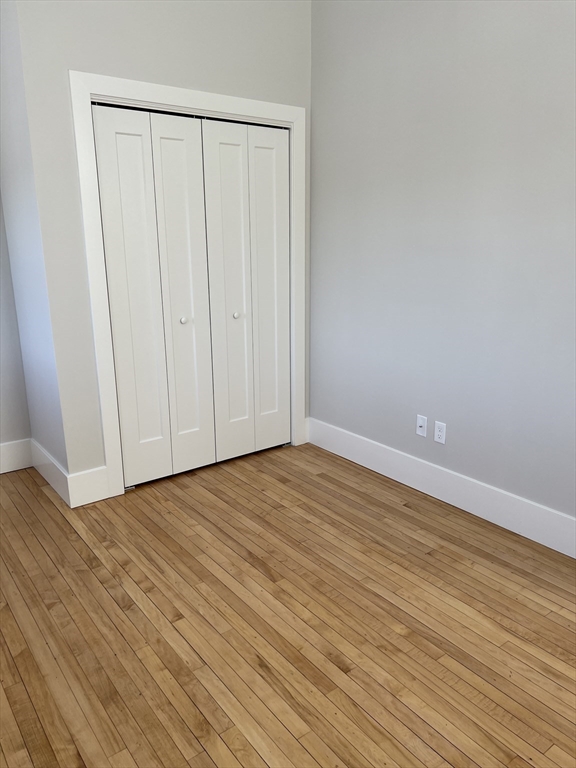 34 St Joseph Street, Unit 21 Fall River, MA 02723 - Photo 6 of 15 a view of an empty room with wooden floor
