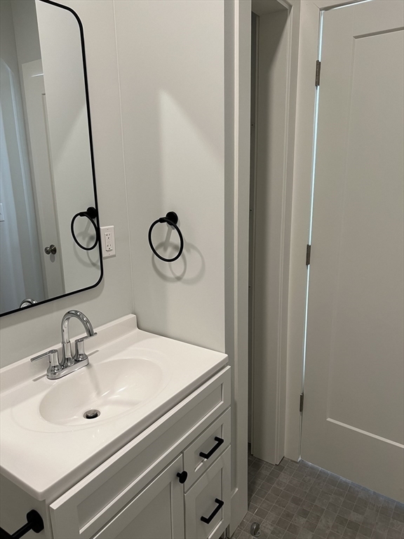 34 St Joseph Street, Unit 21 Fall River, MA 02723 - Photo 7 of 15 a bathroom with a sink and mirror