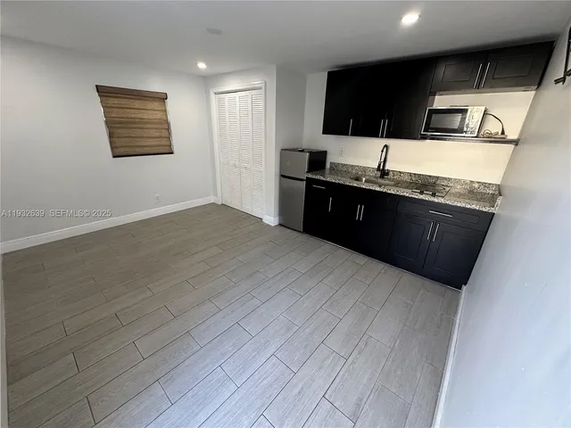 a kitchen with a sink and steel cabinets
