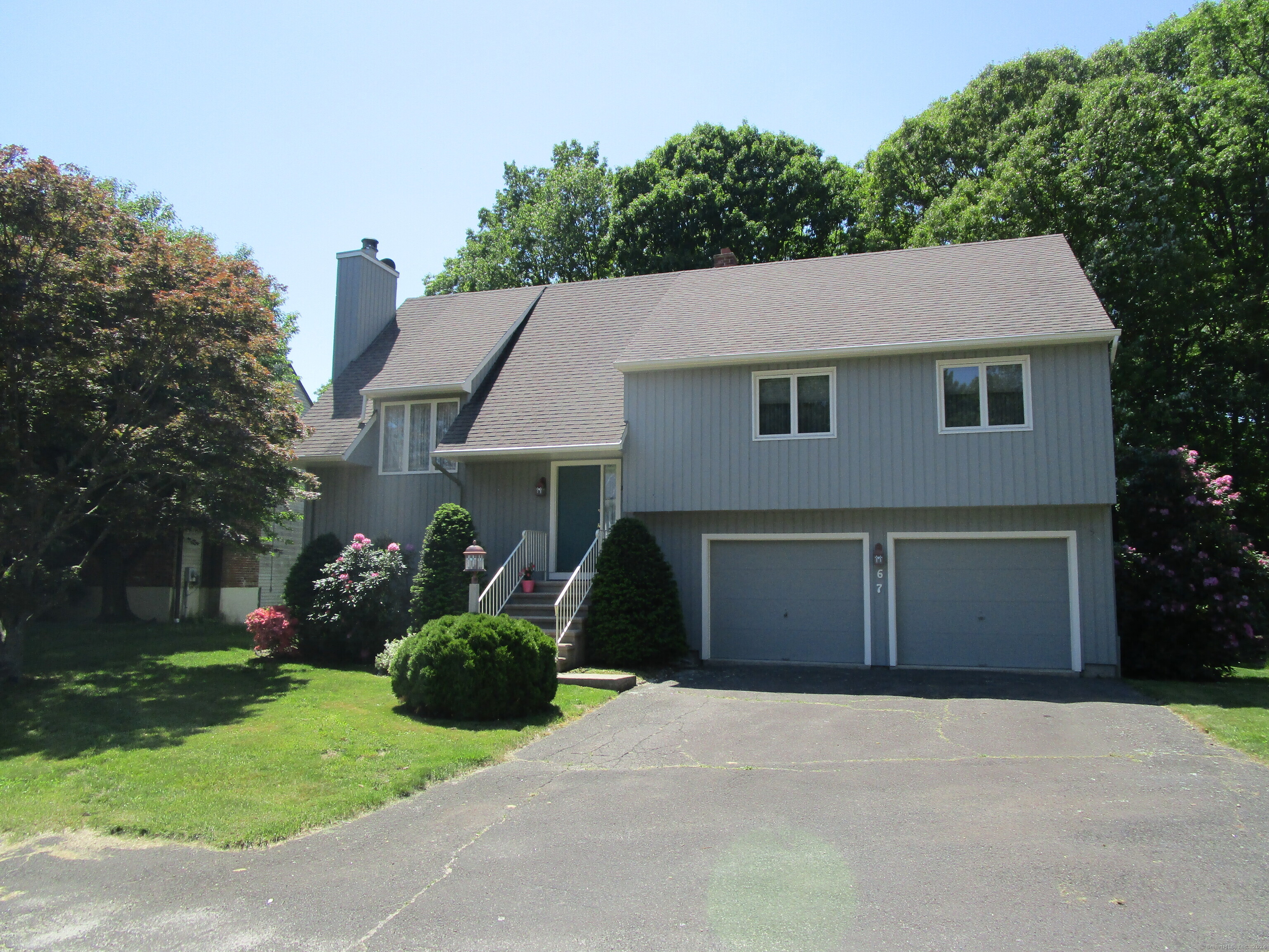 67 Crest Street Waterbury, CT 06708 - Photo 1 of 1 a front view of a house with a yard and garage