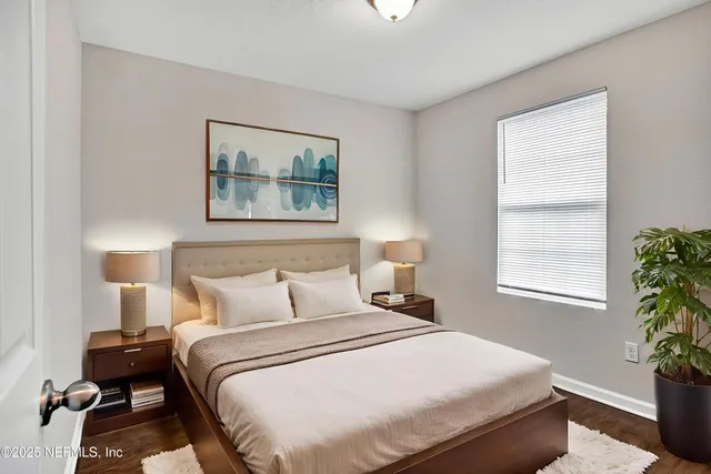 a bedroom with a bed and a potted plant