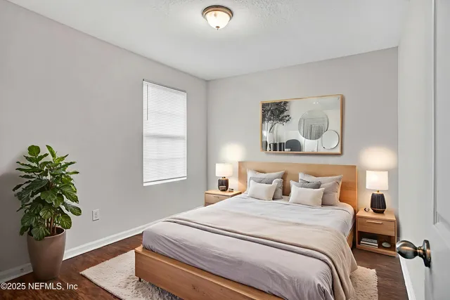 a bedroom with a bed and a potted plant