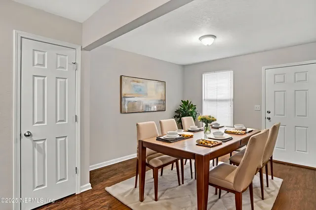 a view of a dining room with furniture window and wooden floor