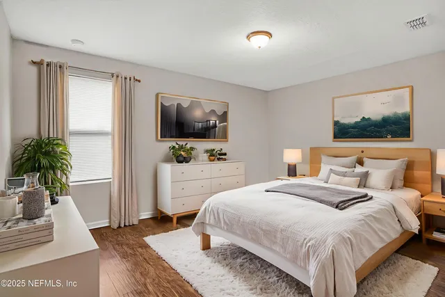 a bedroom with a bed and a flat screen television