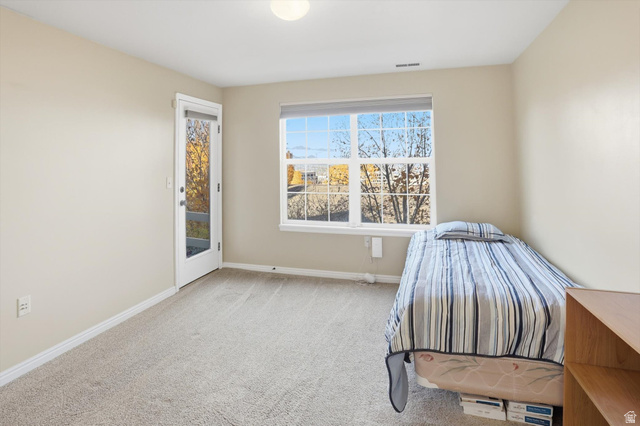 14820 175 East Draper, UT 84020 - Photo 22 of 39 Unfurnished bedroom with light carpet and access to exterior