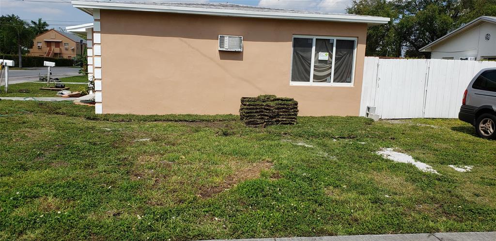 1213-1217 Southwest 3rd Avenue, Unit 1215 Dania Beach, FL 33004 - Photo 3 of 8 a view of a backyard with plants and a tree