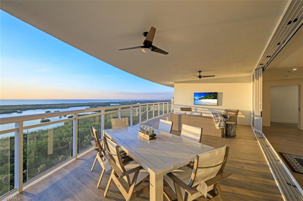 13935 Old Coast Road, Unit 1703 Naples, FL 34110 - Photo 26 of 44 a dining room with furniture and wooden floor