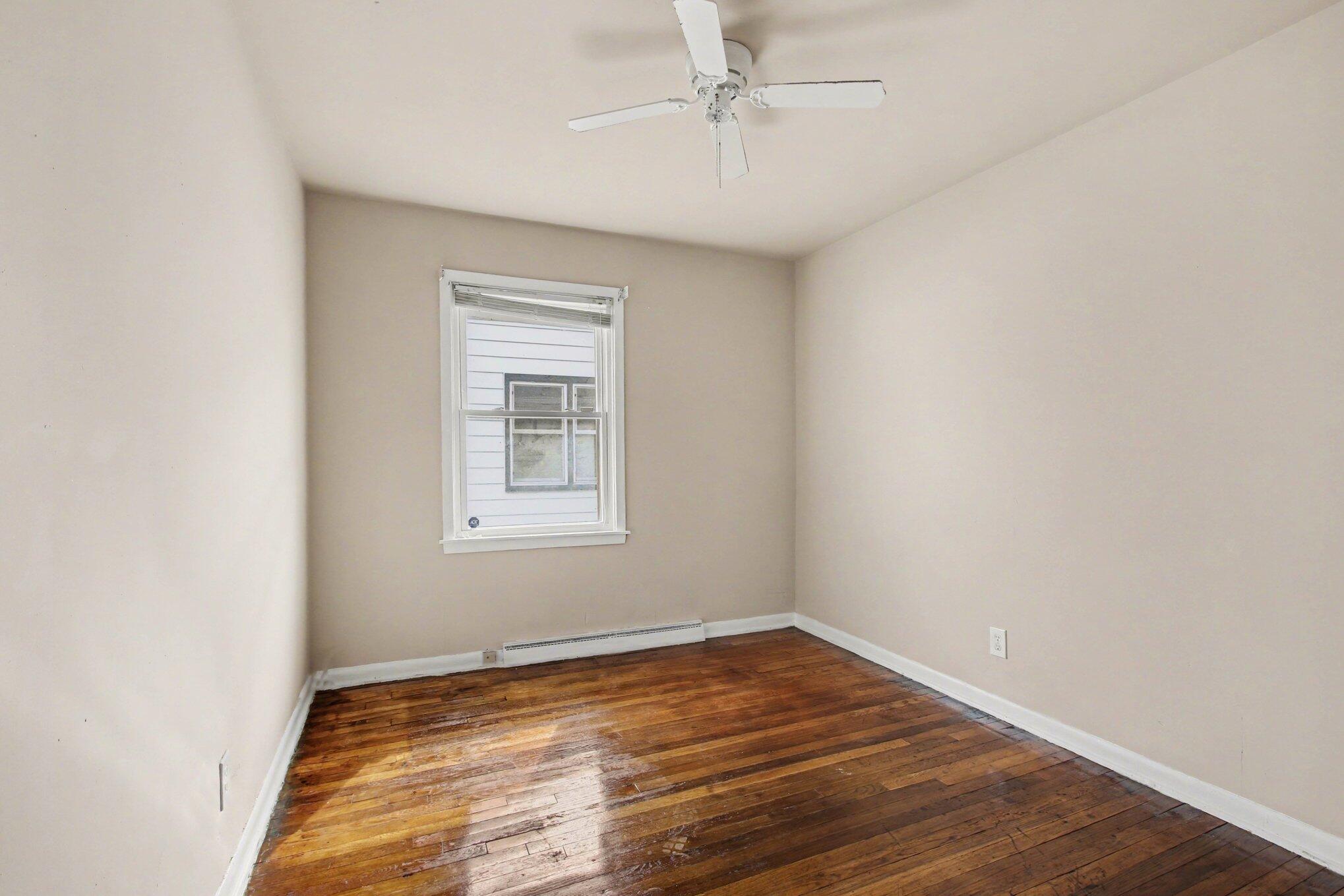 1741 Cleveland Street Gary, IN 46404 - Photo 11 of 16 wooden floor in an empty room with a window