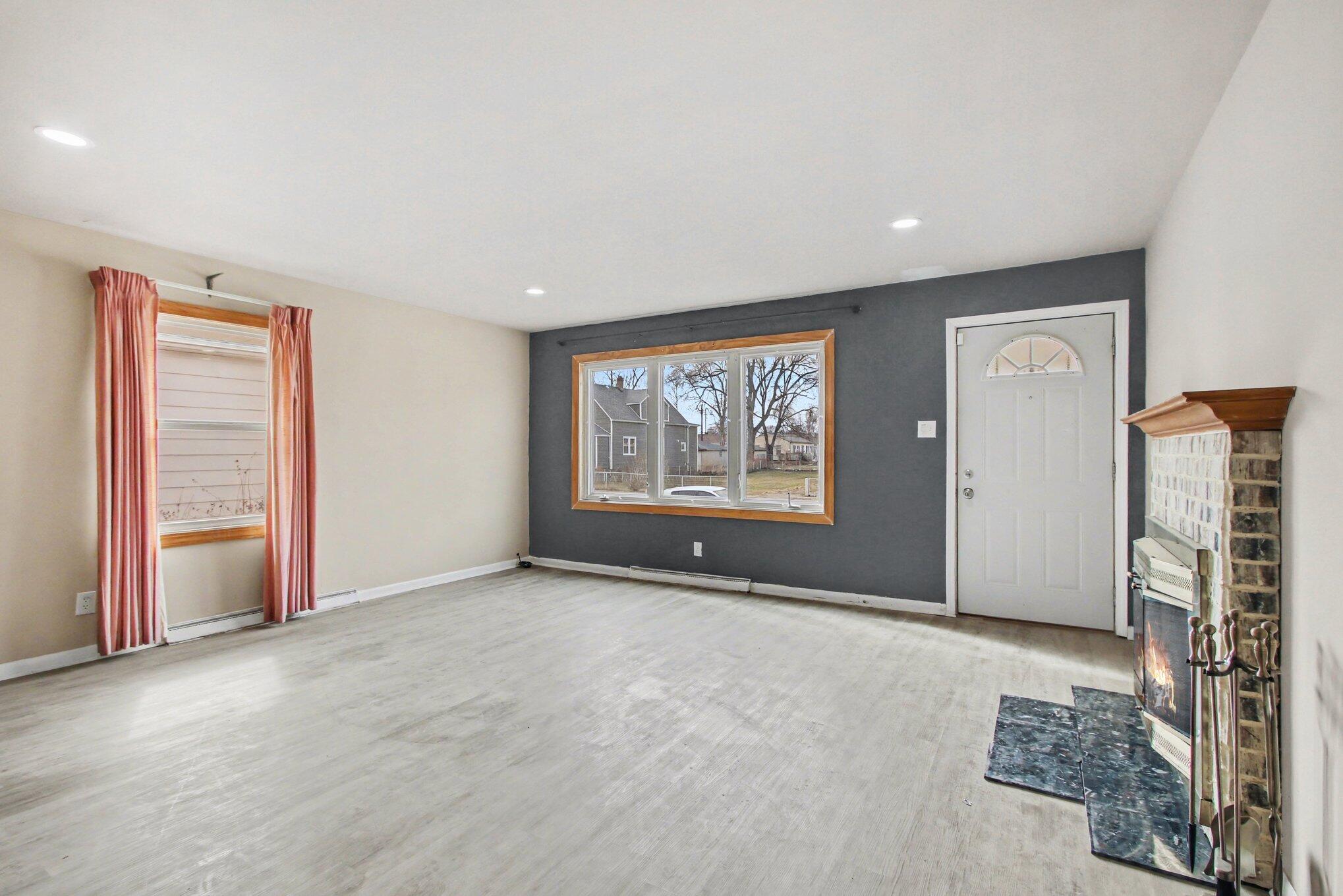 1741 Cleveland Street Gary, IN 46404 - Photo 2 of 16 an empty room with windows