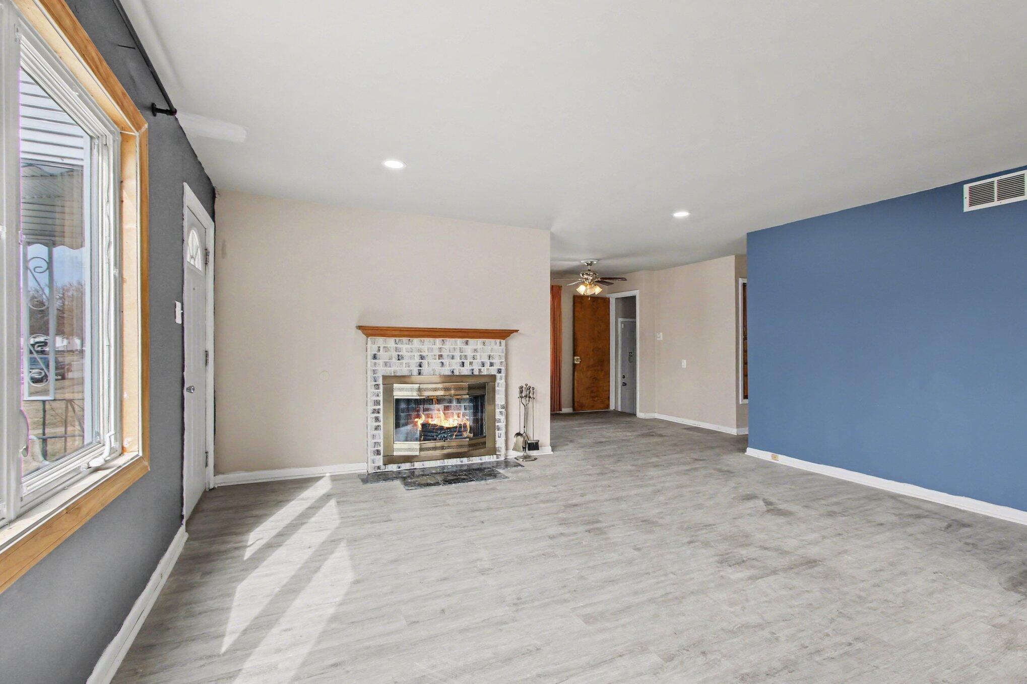 1741 Cleveland Street Gary, IN 46404 - Photo 3 of 16 a view of empty room with fireplace and window