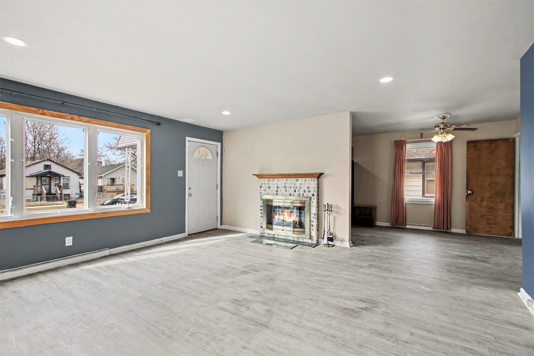 1741 Cleveland Street Gary, IN 46404 - Photo 4 of 16 an empty room with windows and fireplace