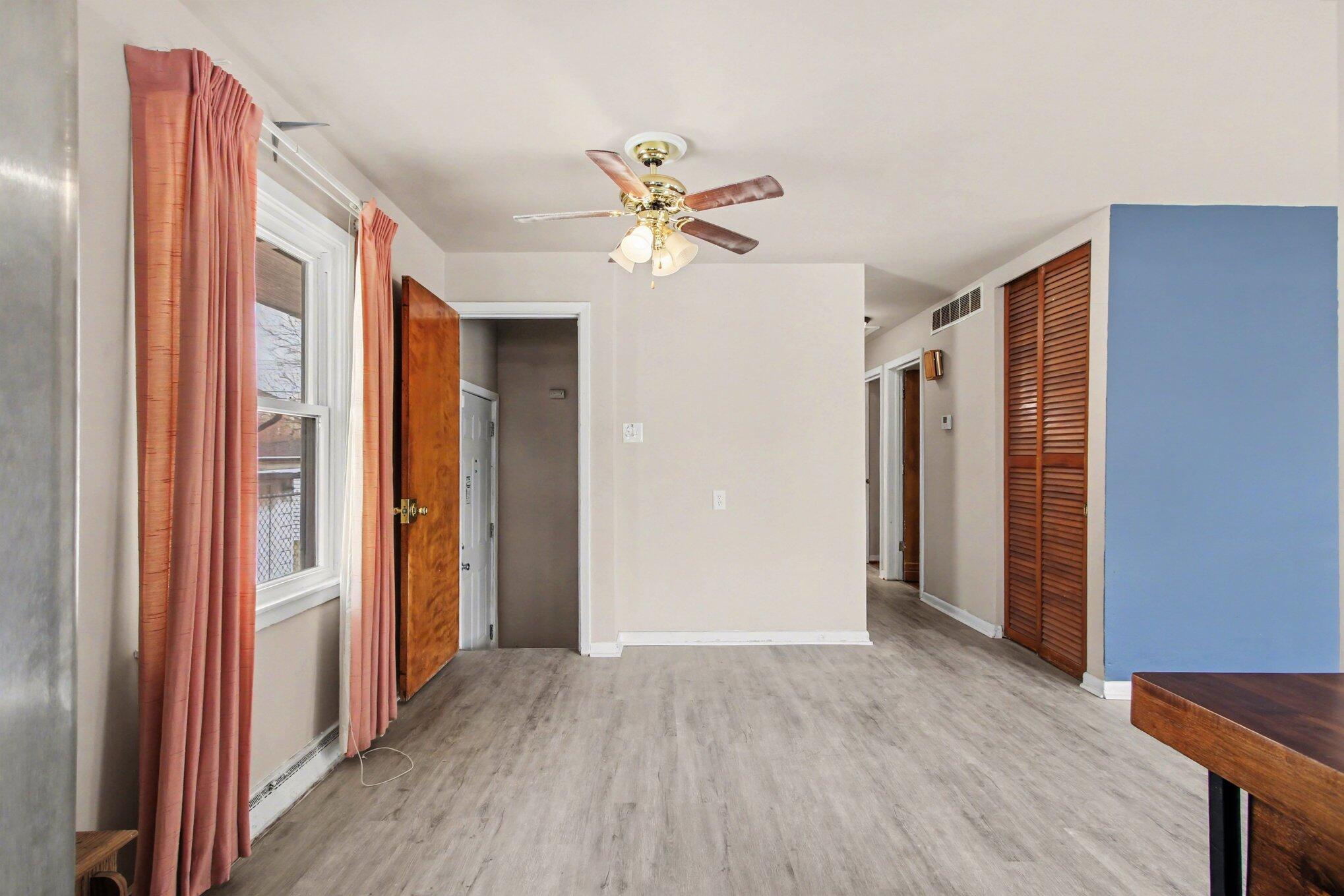 1741 Cleveland Street Gary, IN 46404 - Photo 5 of 16 a view of an empty room with window and a ceiling fan