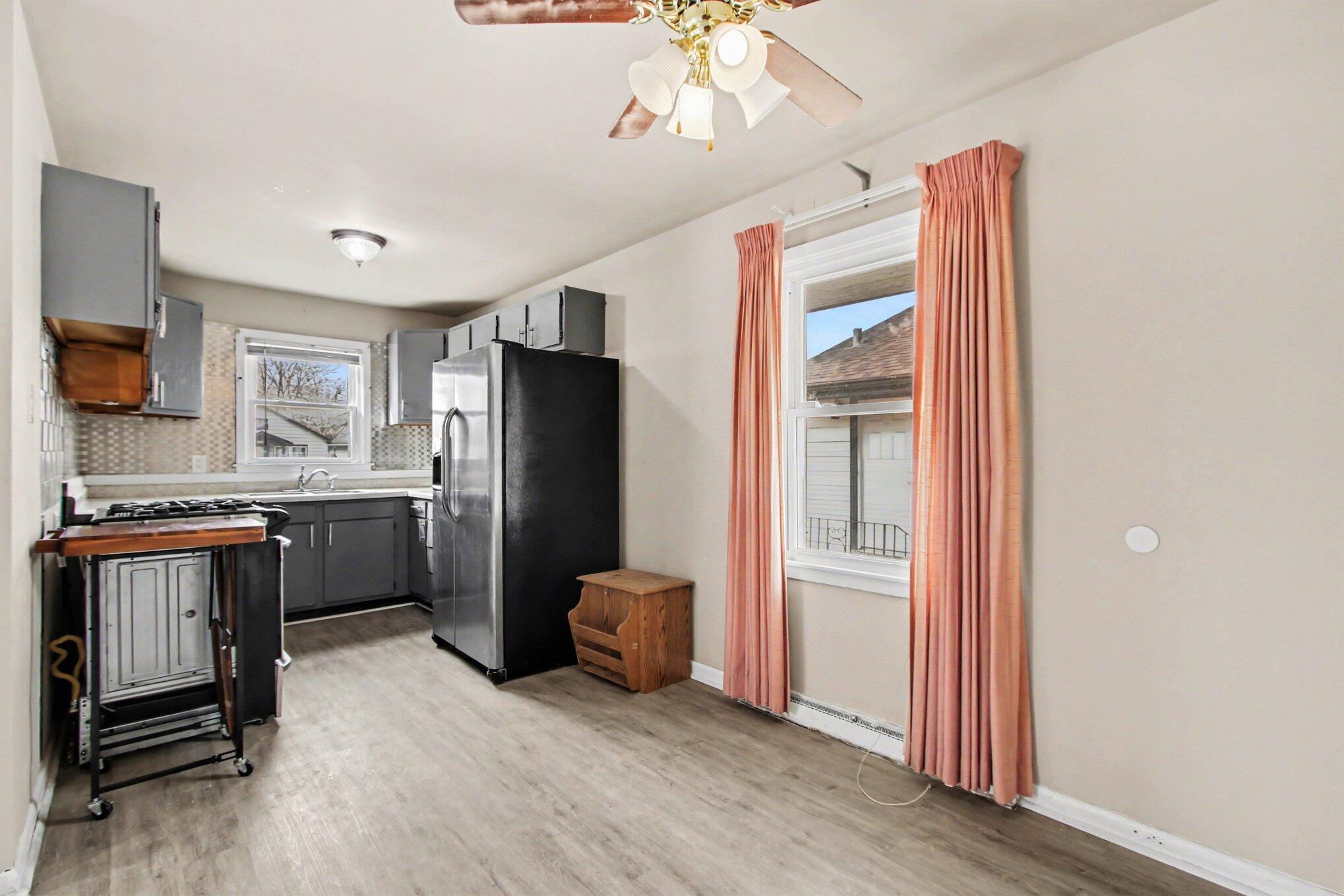1741 Cleveland Street Gary, IN 46404 - Photo 6 of 16 a kitchen with stainless steel appliances a refrigerator and a stove top oven