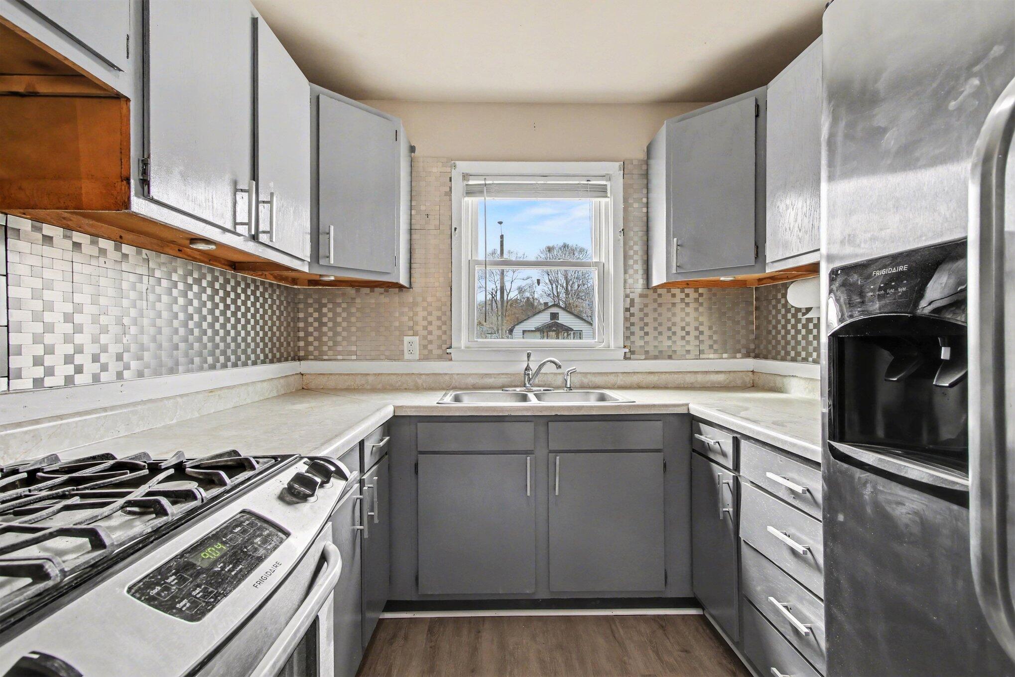 1741 Cleveland Street Gary, IN 46404 - Photo 7 of 16 a kitchen with a stove a sink and a microwave