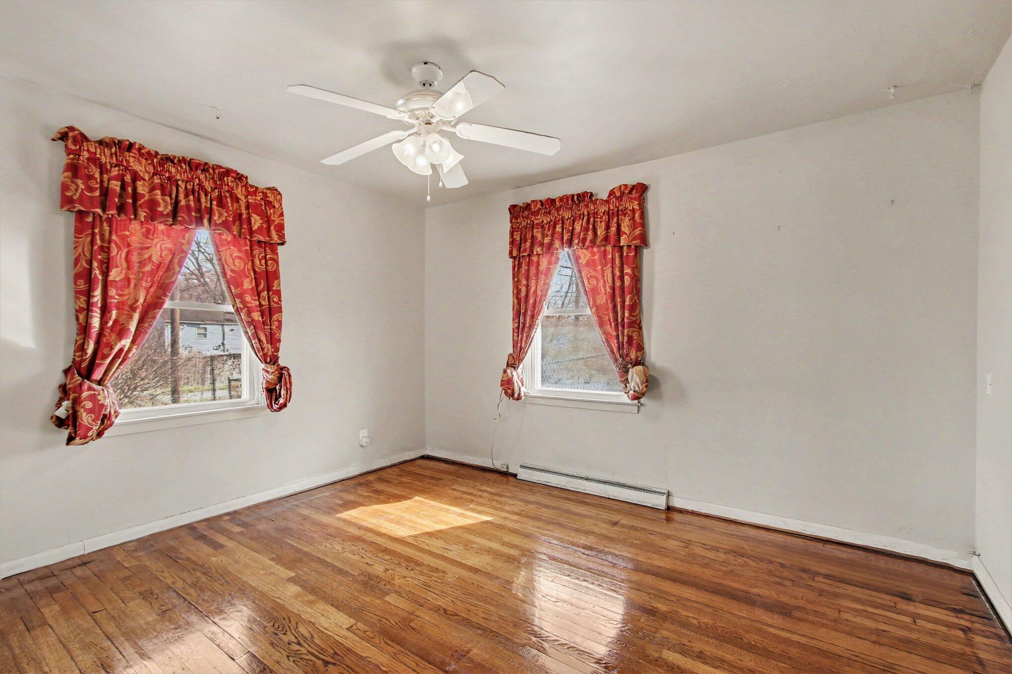 1741 Cleveland Street Gary, IN 46404 - Photo 9 of 16 a view of empty room with window and wooden floor