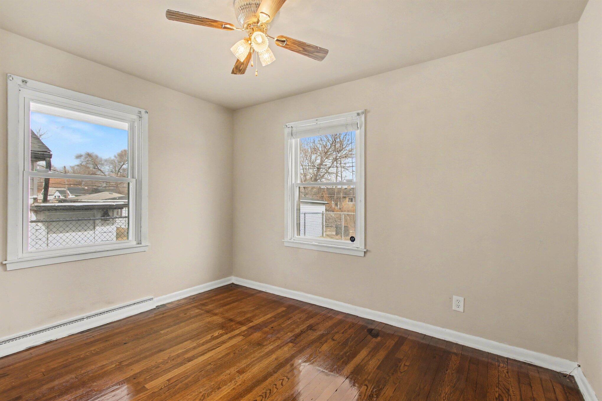 1741 Cleveland Street Gary, IN 46404 - Photo 10 of 16 a view of empty room with wooden floor and fan