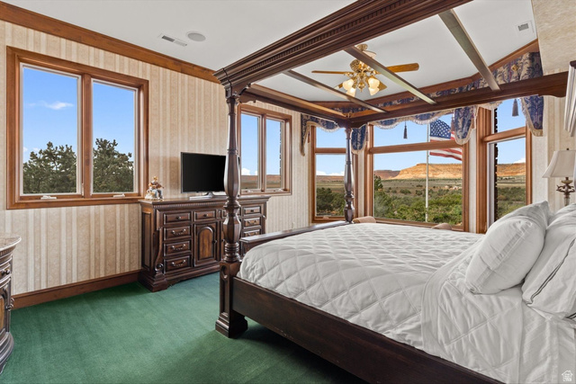 5615 East Eight Mile Gap Road Kanab, UT 84741 - Photo 41 of 81 Bedroom featuring wallpapered walls, dark carpet, and a ceiling fan