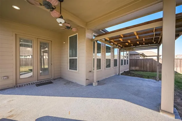 a view of a porch with a table and chairs