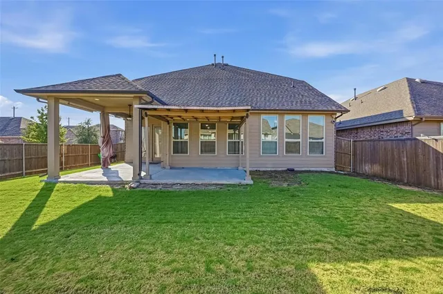 a view of a house with a backyard and porch