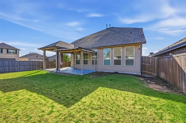 a view of a house with a backyard