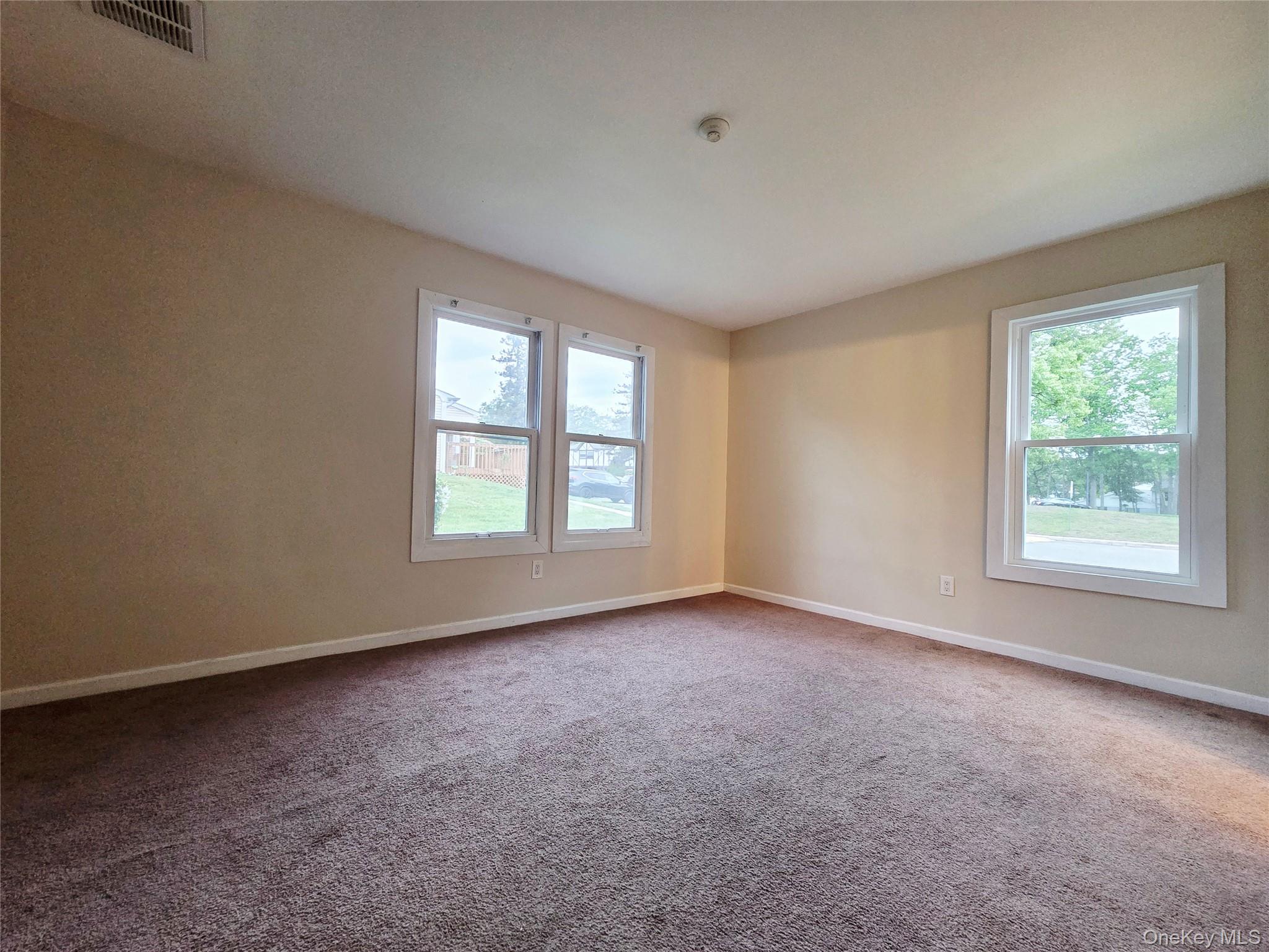 5 Independence Court, Unit 5A Ridge, NY 11961 - Photo 6 of 9 an empty room with windows
