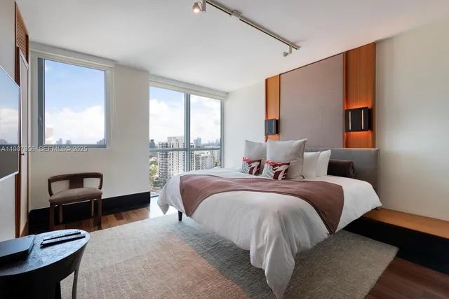 a bed room with a bed and a chair