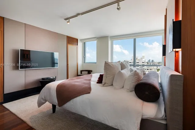 a bedroom with furniture and a flat screen tv