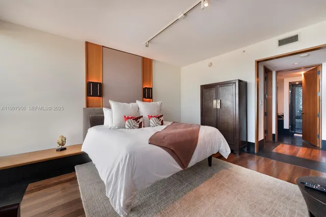 a bedroom with a bed and a mirror