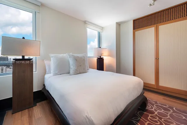 a bedroom with a bed and a flat screen tv