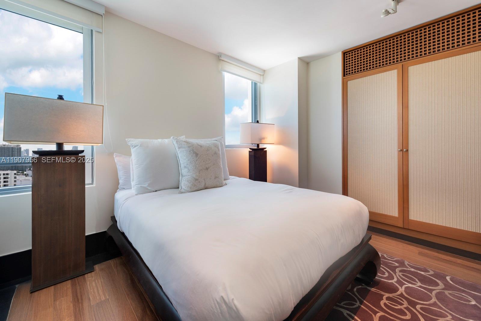 101 20th Street, Unit 2004 Miami Beach, FL 33139 - Photo 18 of 19 a bedroom with a bed and a flat screen tv