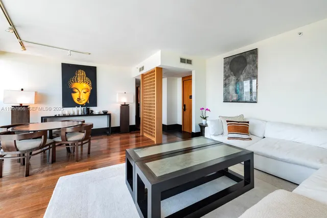 a living room with furniture a rug and a flat screen tv
