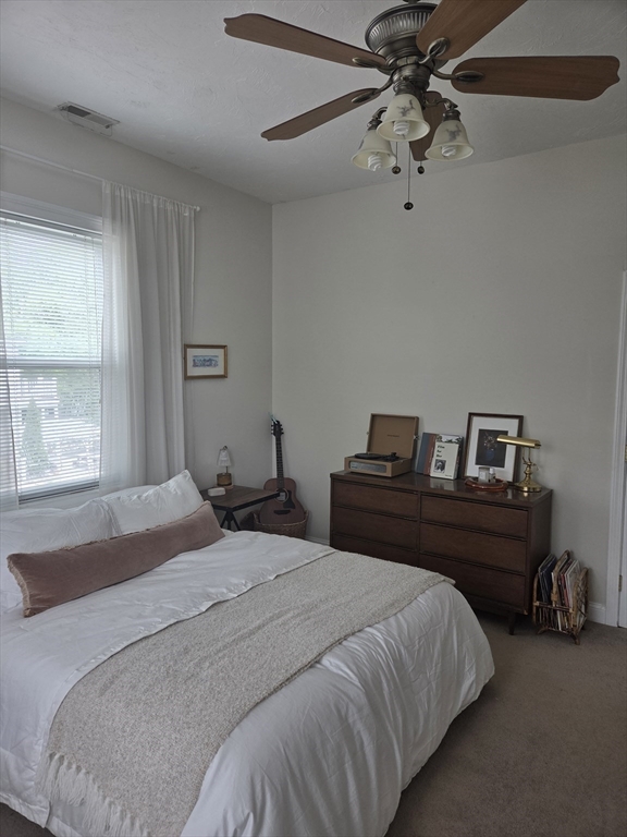 84 South, Unit 84 Waltham, MA 02451 - Photo 8 of 9 a bedroom with a bed and a chandelier