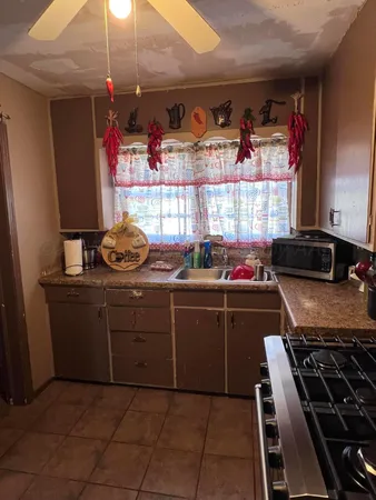 a kitchen with a stove and a window