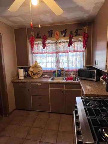 a kitchen with a stove and a window