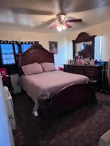 a bedroom with a bed and a mirror on dresser