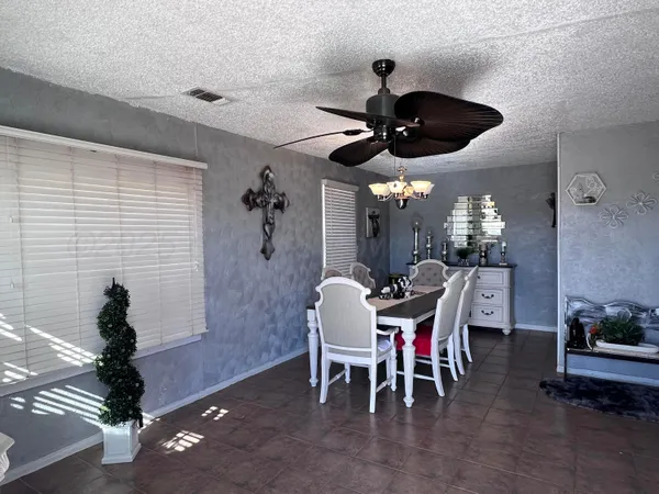 a view of a dining room with furniture and chandelier