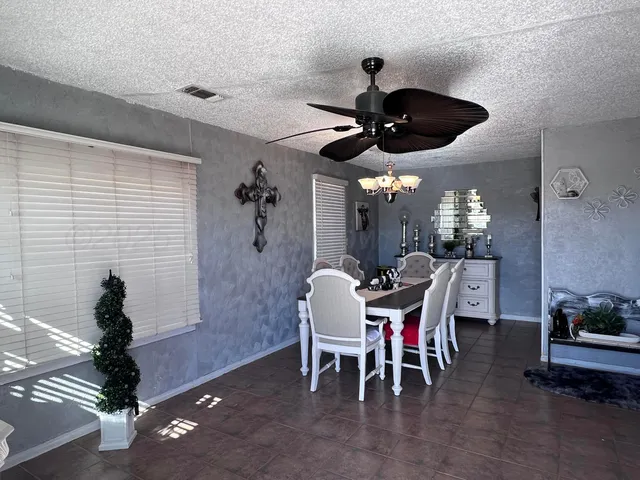 a view of a dining room with furniture and chandelier