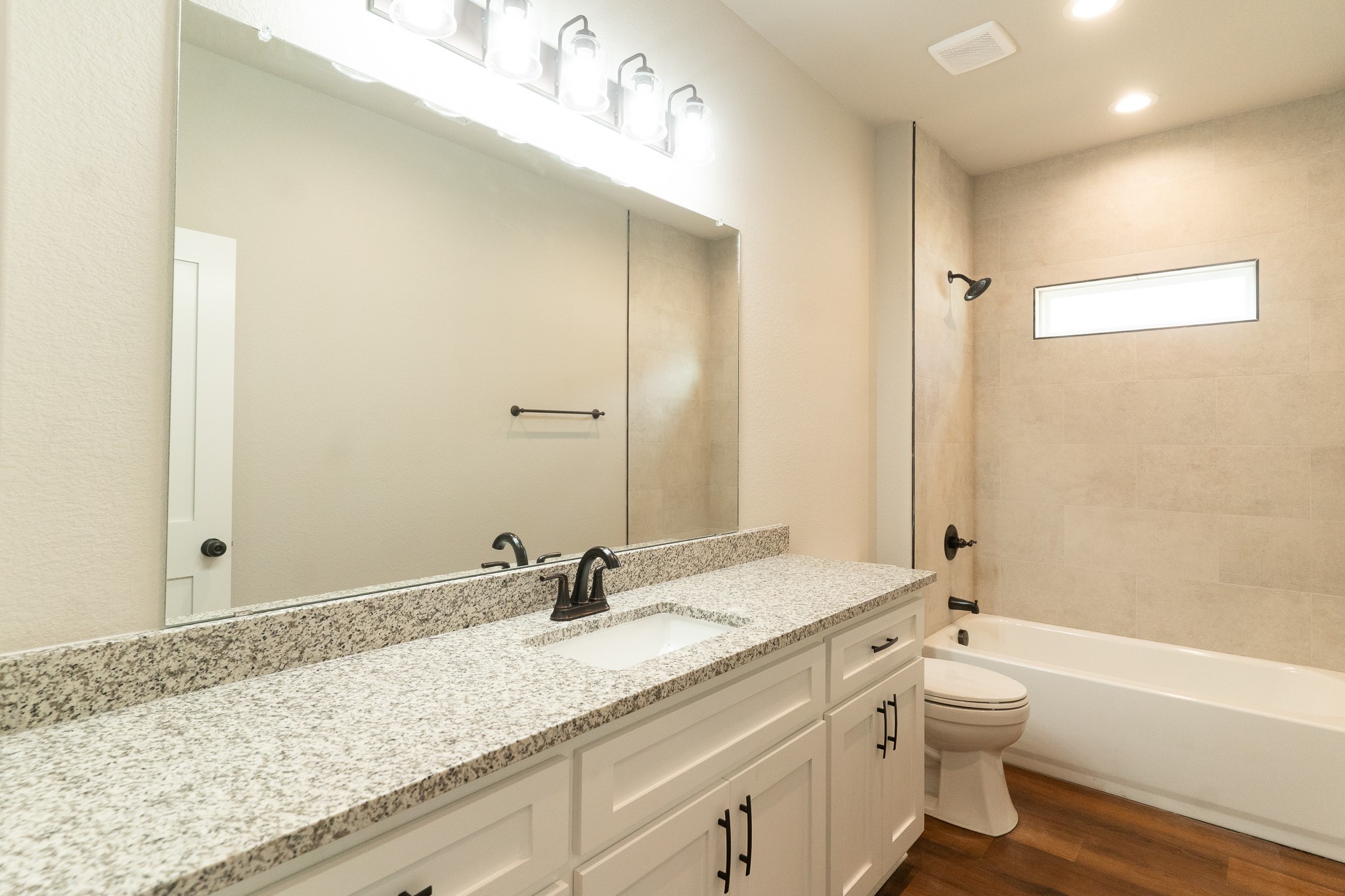 305 String Prairie Way Smithville, TX 78957 - Photo 20 of 26 a bathroom with a granite countertop sink toilet and shower