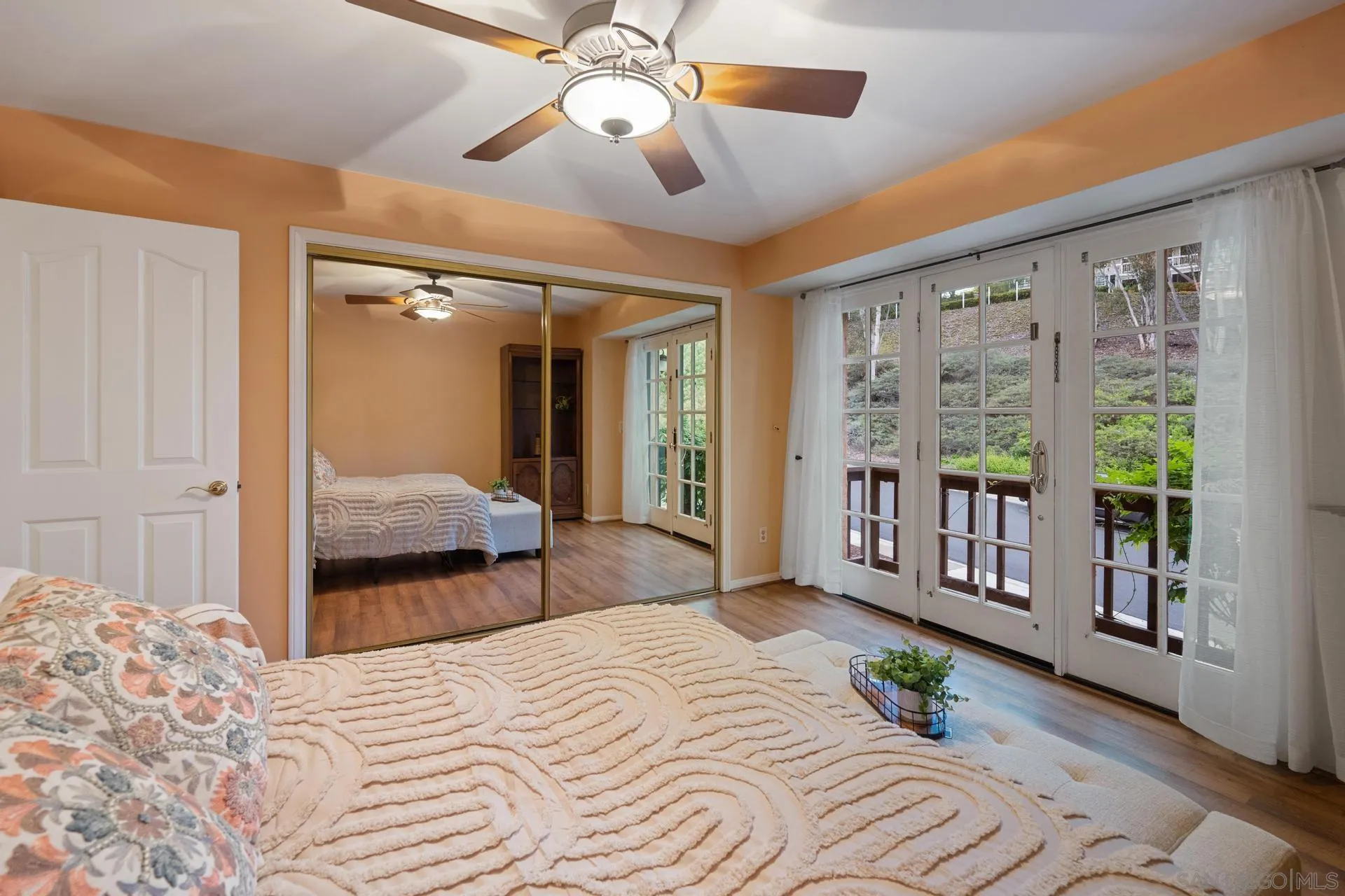 10575 Spruce Grove Avenue San Diego, CA 92131 - Photo 13 of 33 a bedroom with a large bed and a chandelier