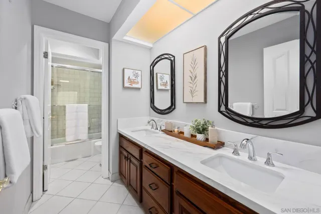 a bathroom with a double vanity sink double mirror and bathtub