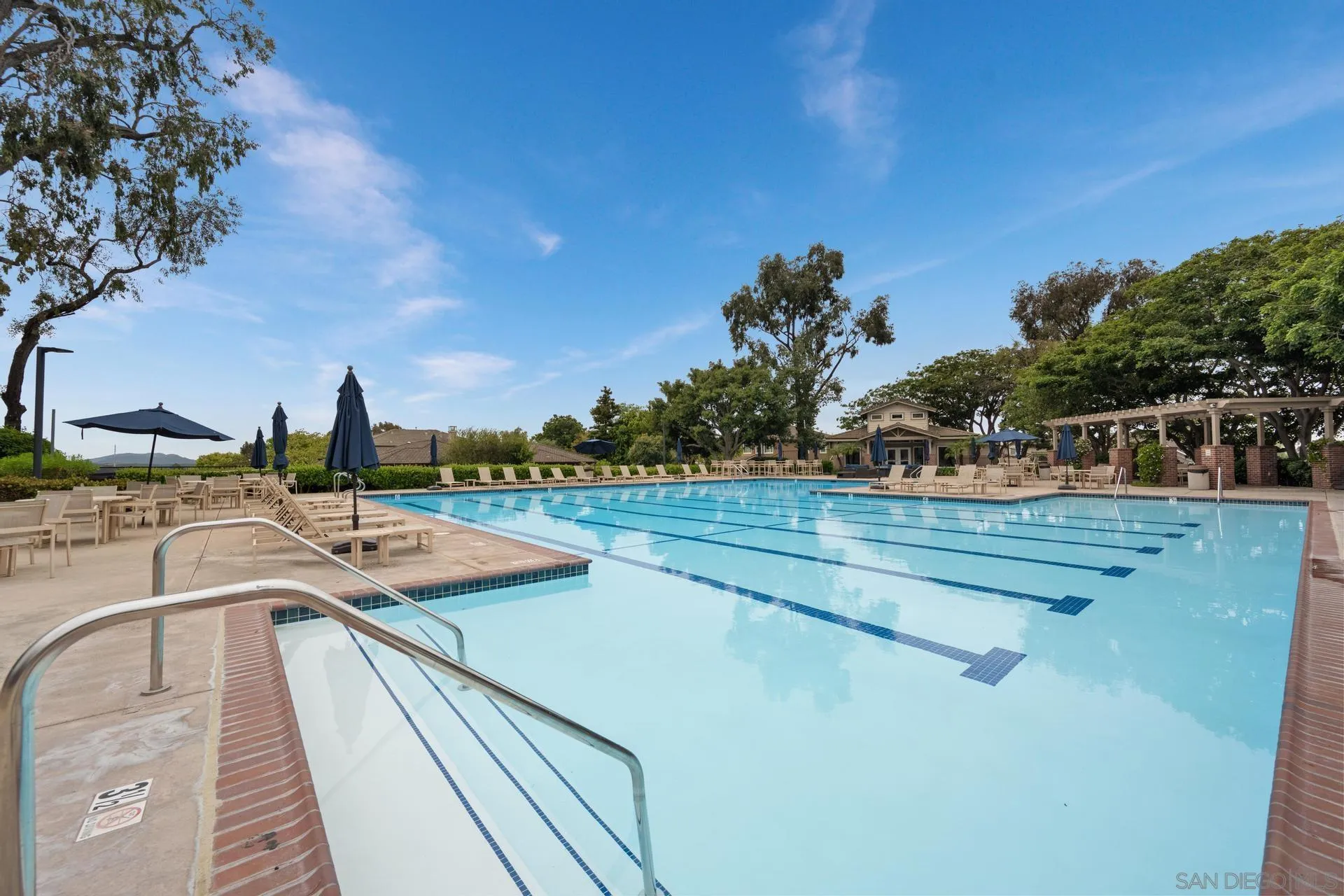 10575 Spruce Grove Avenue San Diego, CA 92131 - Photo 18 of 33 a view of a swimming pool with a lounge chair