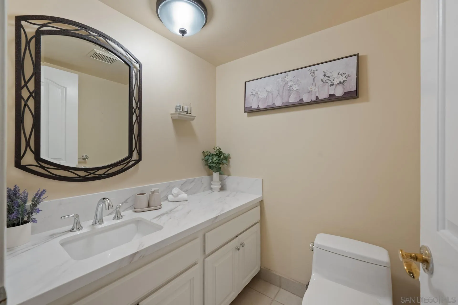 10575 Spruce Grove Avenue San Diego, CA 92131 - Photo 20 of 33 a bathroom with a granite countertop sink and a mirror