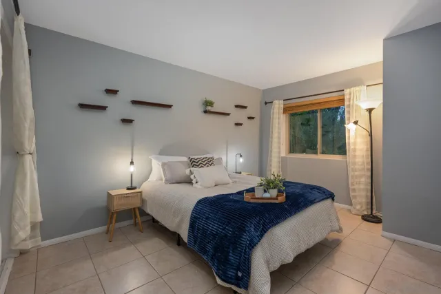 a bedroom with a bed and a window